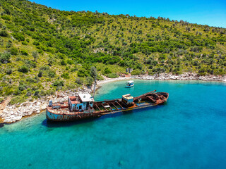 Aerial view over rusty shipwreck of an old cargo boat at Peristera island near Alonissos, Greece