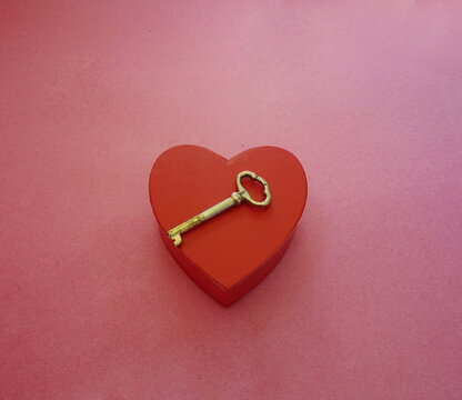 Heart Shaped Box, Brass Key on Red Background