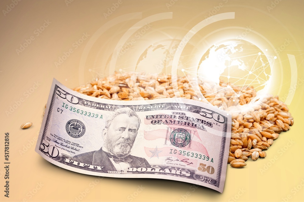 Poster A wheat next to money and grains of wheat scattered on the table. The concept of a fruitful year. Export and import.