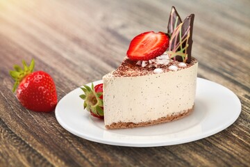 Tasty sweet cake on white ceramic plate. Popular dessert in minimal style