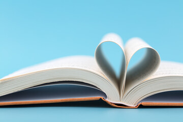 The book is opened and folded into a heart shape