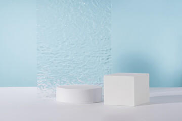 Acrylic plate, podium, background for cosmetic product packaging on blue backdrop with stylish...