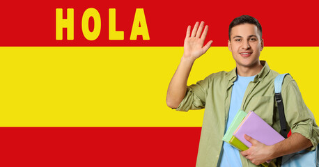 Portrait of male student and word HOLA (HELLO) against flag of Spain © Pixel-Shot
