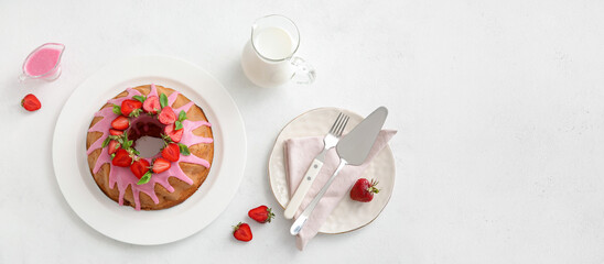 Obraz na płótnie Canvas Tasty strawberry cake with jug of milk on white background, top view