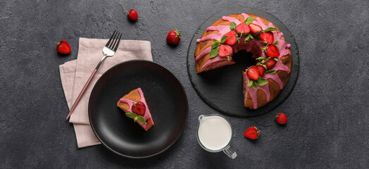 Tasty strawberry cake and jug of milk on dark background
