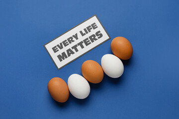 Chicken eggs and paper sheet with text EVERY LIFE MATTERS on color background