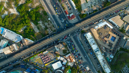 Aerial view Automobile cars drive at cross road in the City Town. Skycrapers buildings at downtown streets. Business center City Roads Traffic road Junction Freeway transportation logistics concept.