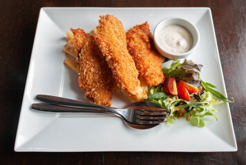 deep fried fish and chips with salad and sour sauce