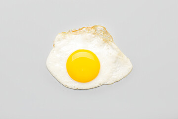 Tasty fried egg on light background