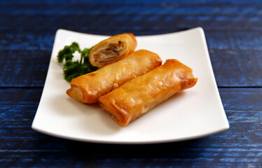 Multiple fried spring rolls on the table