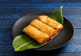Multiple fried spring rolls on the table