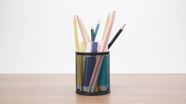 Stop motion animation colored pencils in black transparent stand for design presentation ideas in your works.