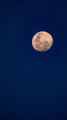 full moon over blue sky