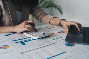Woman accountant working with computer and calculator for business and financial expense