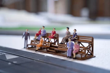 Tuinposter Miniature doll in race track, Miniature people watching racing cars in the field. Selective Focus. © somchairakin
