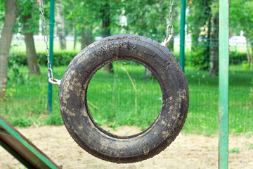 Suspended car tire wheel for dog training in park