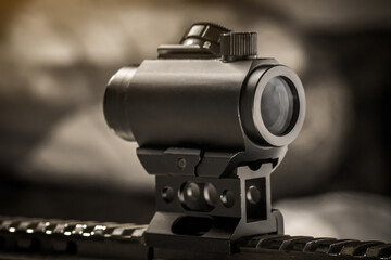 Aiming tactical red dot sight on AR15 assault rifle