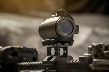 Aiming tactical red dot sight on AR15 assault rifle