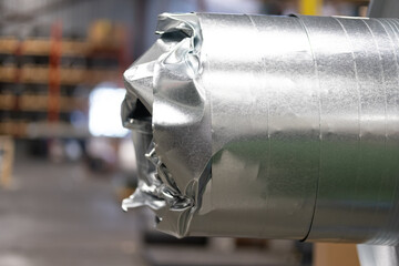 Damaged metal roll of coil on decoiling machine