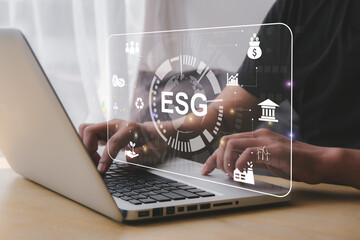 ESG - Business people use computers to analyze ESG in concepts, environment, society and governance.  Strategies for investing in businesses that love the world, clean energy, green business