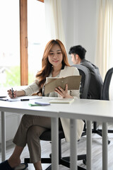Pretty asian businesswoman concentrated working on her assignment.