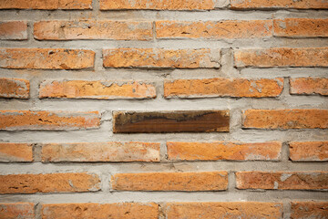 Brick wall background on construction site.Different wood square and red bricks background.Brick wall, abstract background texture and copy space.