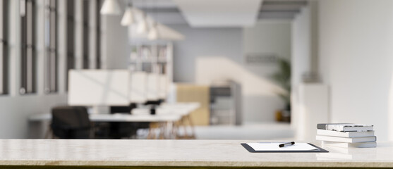 Office tabletop workspace with clipboard paper and copy space over blurred office background