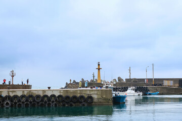 Fototapeta premium Fishing village full of anchored fishing boat in cloudy day