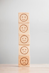 emotion face symbol on wooden blocks. Service rating, ranking, customer review, satisfaction, evaluation and feedback concept - obrazy, fototapety, plakaty