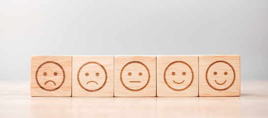 emotion face symbol on wooden blocks. Service rating, ranking, customer review, satisfaction,...