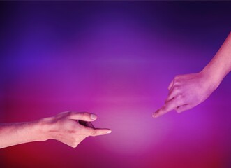 Moment of weightless. Two human hands trying to touch each other on purple background in neon light. Concept of human relation, community, togetherness, symbolism, culture and history
