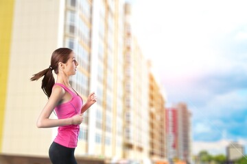 Attractive beautiful woman wearing sportswear running. Fit woman jogging outdoor. Workout exercise