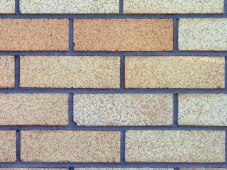 Closeup of an orange and sand coloured brick wall