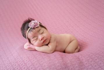 Smiling newborn baby with Mohawk hair sleeping