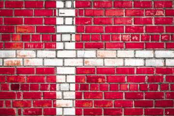 National  flag of the  Denmark on a grunge brick background.