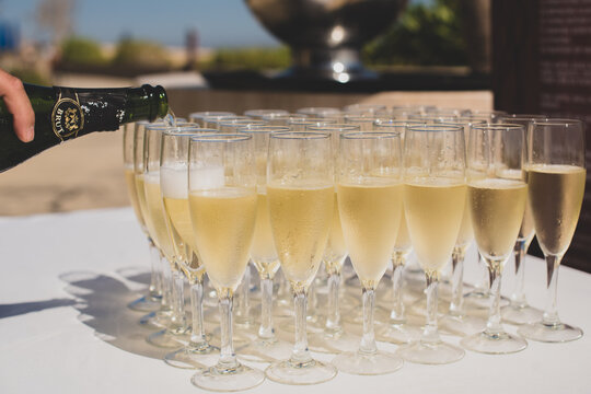 Los Cabos, Mexico Jun 2022 beautiful close up photography of champagne serving / poring aligned glasses