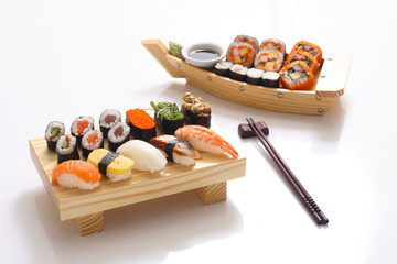 Maki Sushi Rolls on bamboo board. Sushi set on White background.