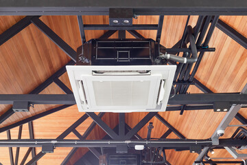 Modern ceiling mounted cassette type air conditioning system in coffee shop