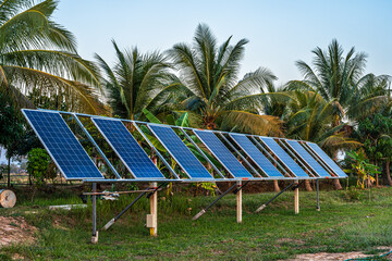 photovoltaic solar power panel for agriculture in a rural houses area Agricultural fields blue sky background,Agro-industry of household Rural style in Thailand, smart farm alternative clean energy.