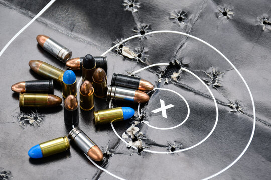 9mm pistol bullets on black leather floor, soft and selective focus on, concept for training and practising shooting to protect life and properties around the world.