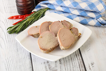Baked pork tenderloin served rosemary