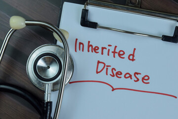 Concept of Inherited Disease write on a paperwork with stethoscope isolated on Wooden Table.