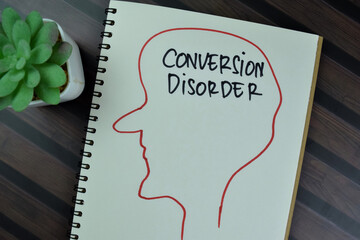 Concept of Conversion Disorder write on a book isolated on Wooden Table.