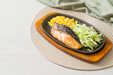 grilled salmon fillet steak on hot plate