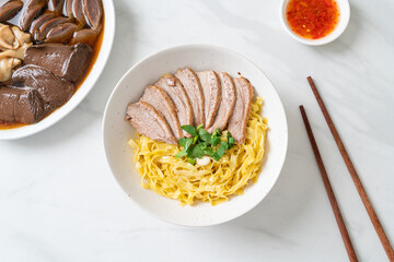 dried duck noodles in white bowl