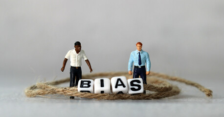 Business concept with white cube arranged in the word  ’BIAS' and miniature people. The concept...