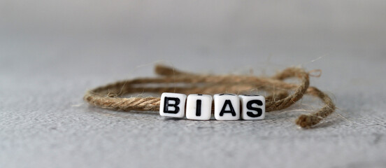 Business concept with white cube arranged in the word  ’BIAS' and rope. White cube miniature.
