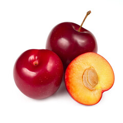 Ripe natural plums. In the foreground is half a plum.