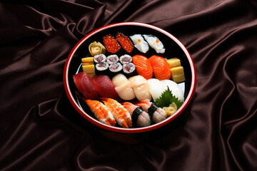 Sushi Set sashimi and sushi rolls served in traditional Japan round plate