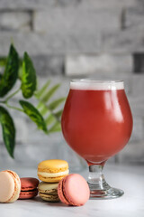 kriek beer with multi colored macaroons still life